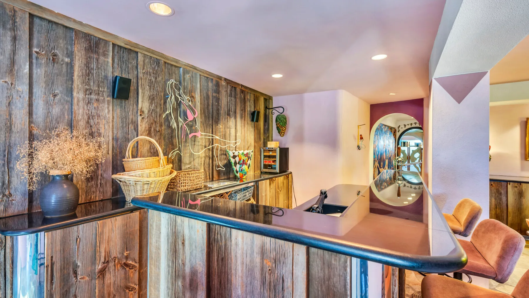 A colorful reception counter with a decorative wood-paneled wall and seating.