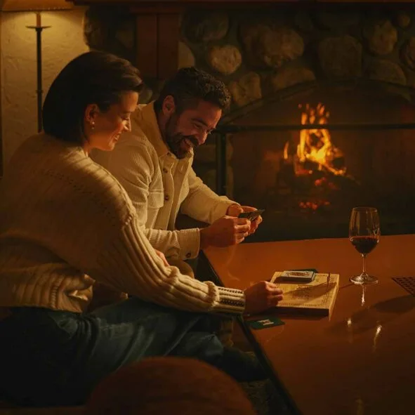 Guests playing a game near the fireplace