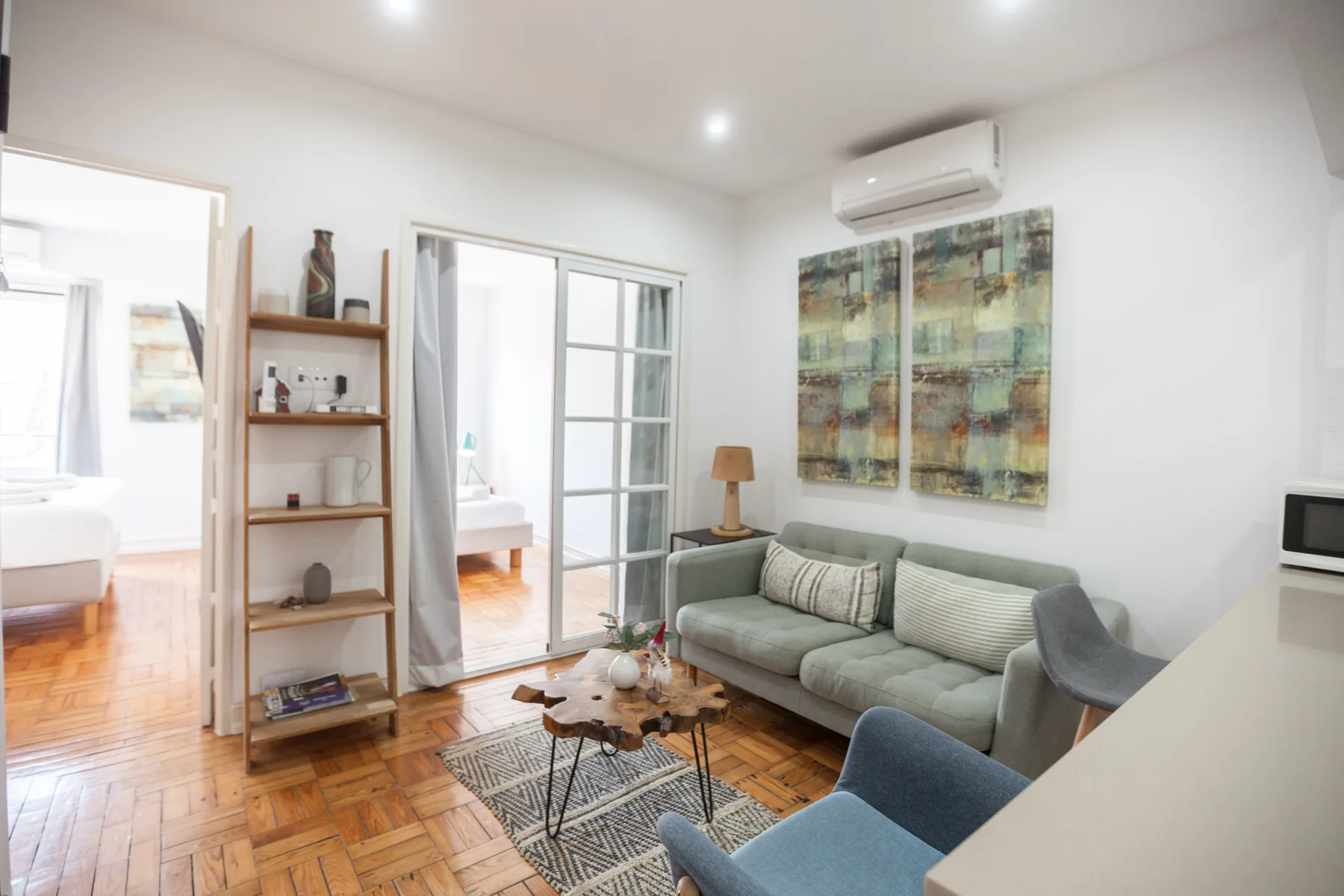 Living room with seating, a coffee table, and large wall art.