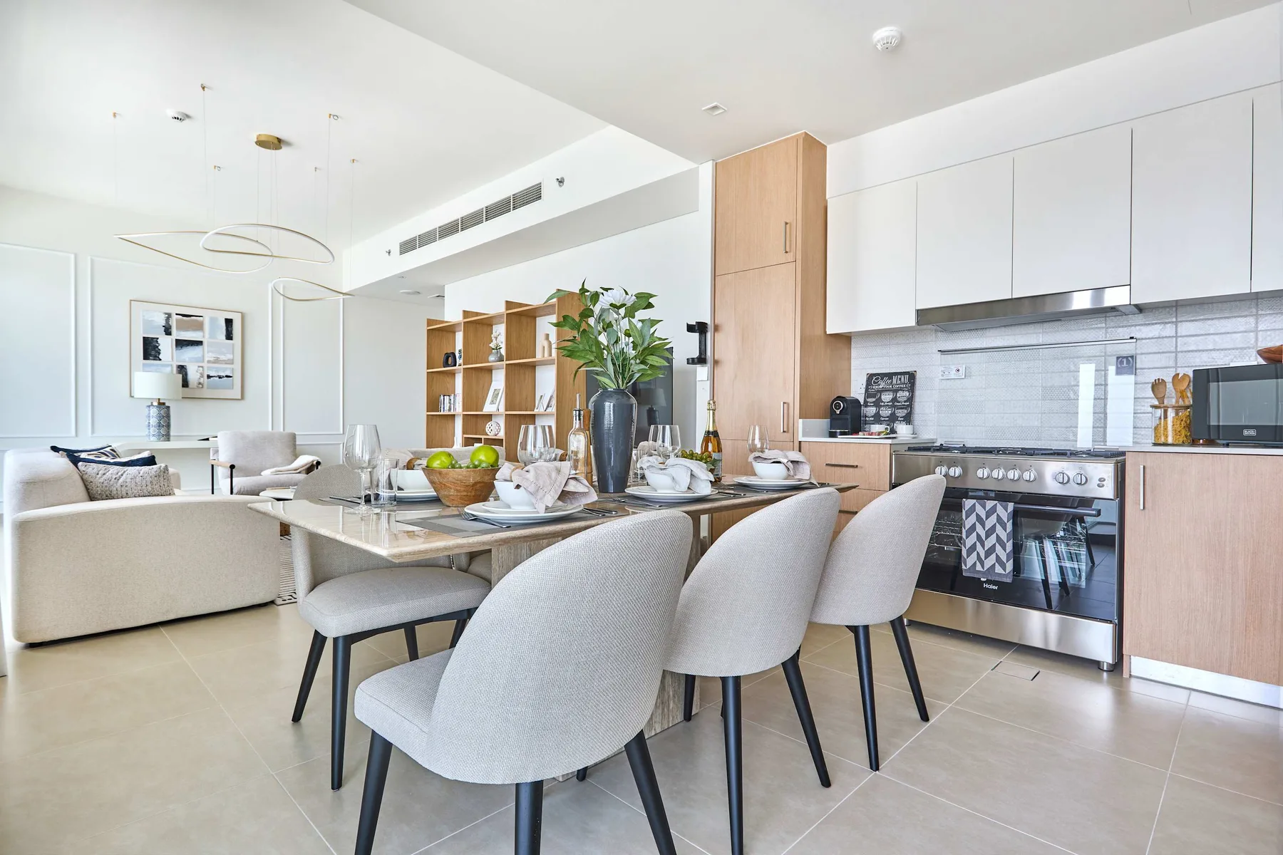 A bright open-plan kitchen and dining area with a set dining table.