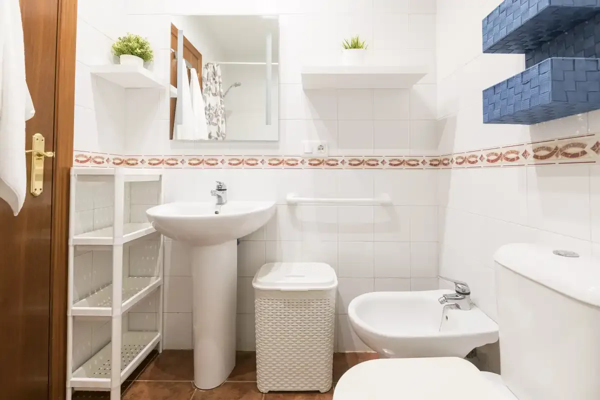 A tiled bathroom with a sink and toilet.