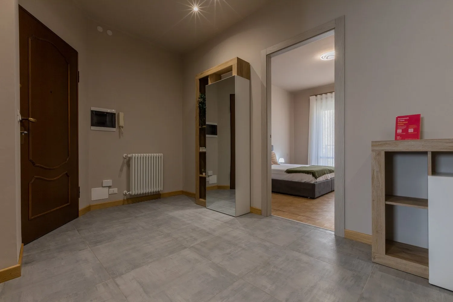 An entry hall with a doorway opening into a bedroom.