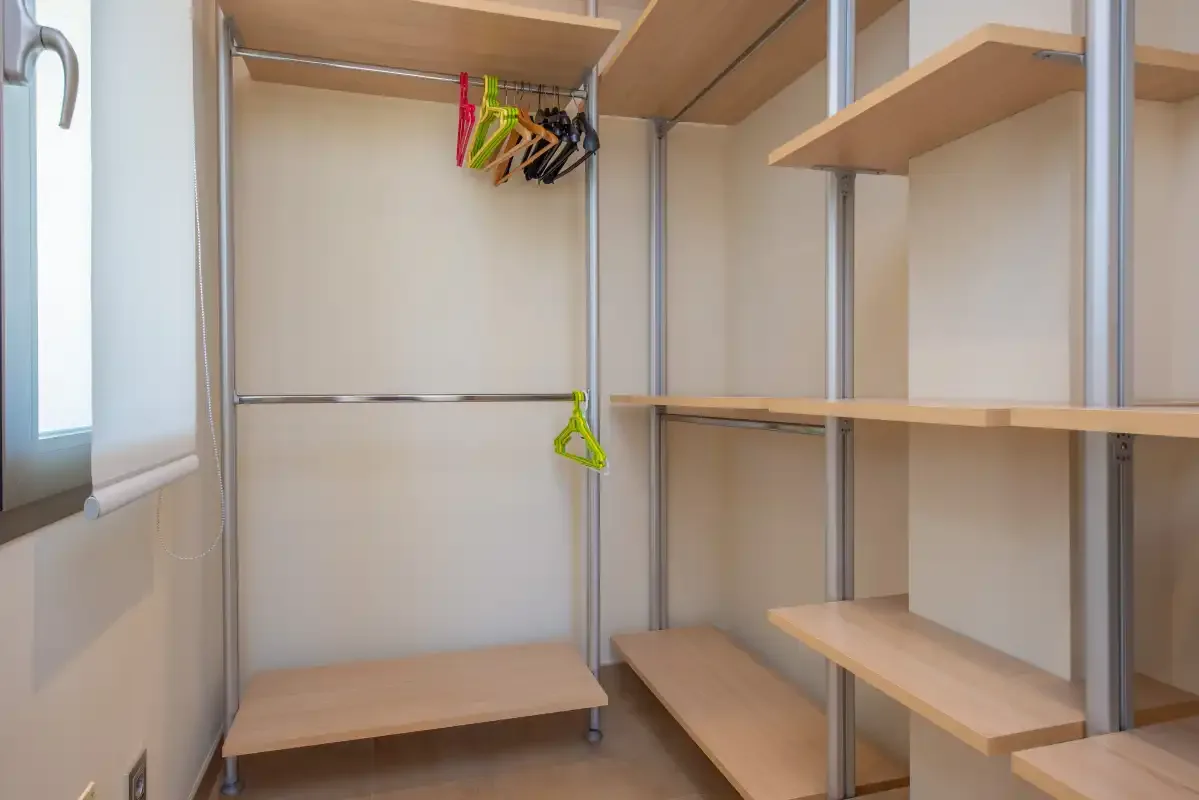 A walk-in closet with open shelving and hanging space.