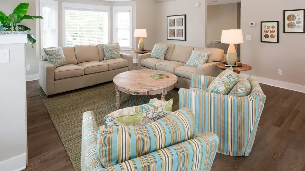 A living room with a seating area arranged around a round coffee table.