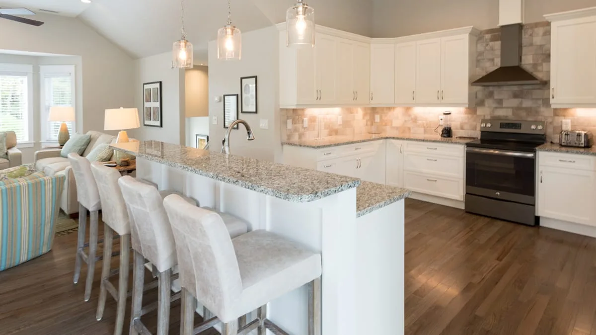 An open kitchen and dining area with a large island and seating.