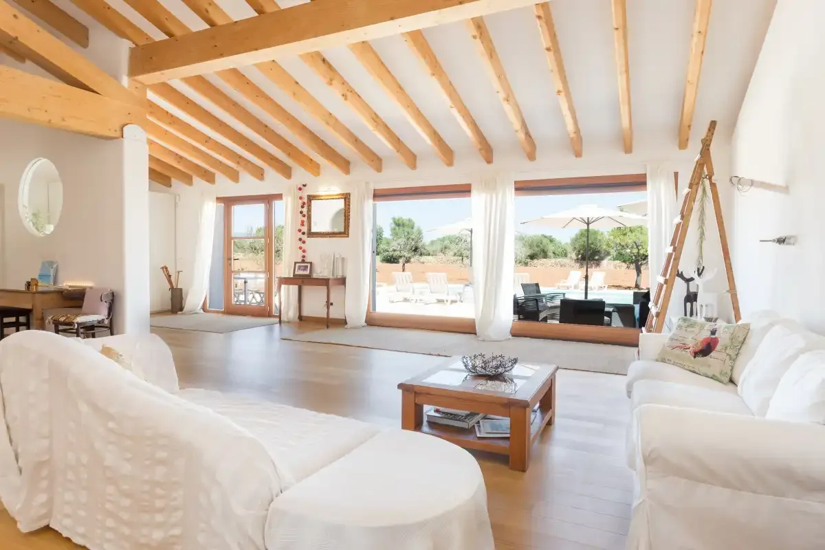 A bright living room with seating and glass doors opening onto a patio.