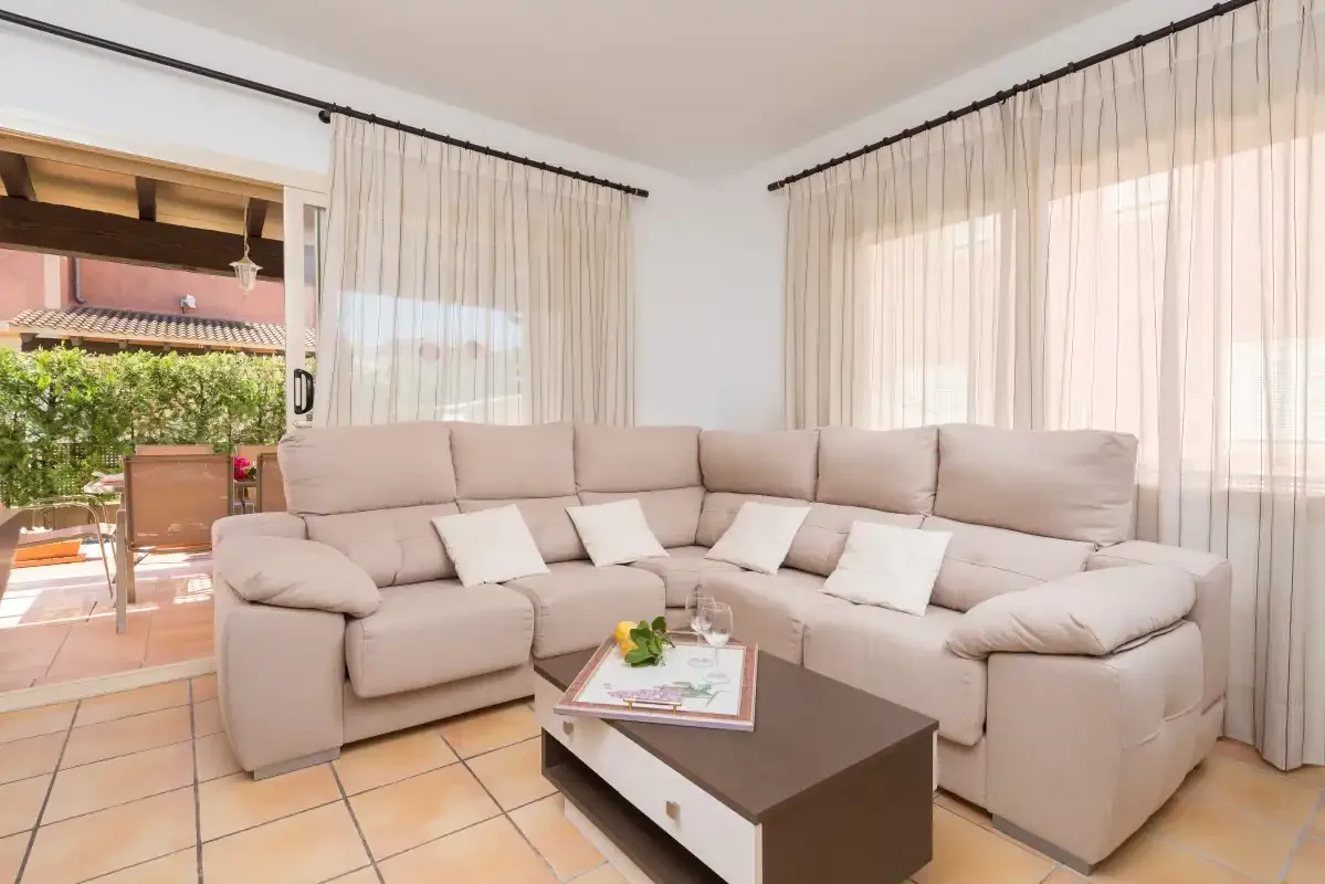 A living room with a large sectional seating area and a coffee table.