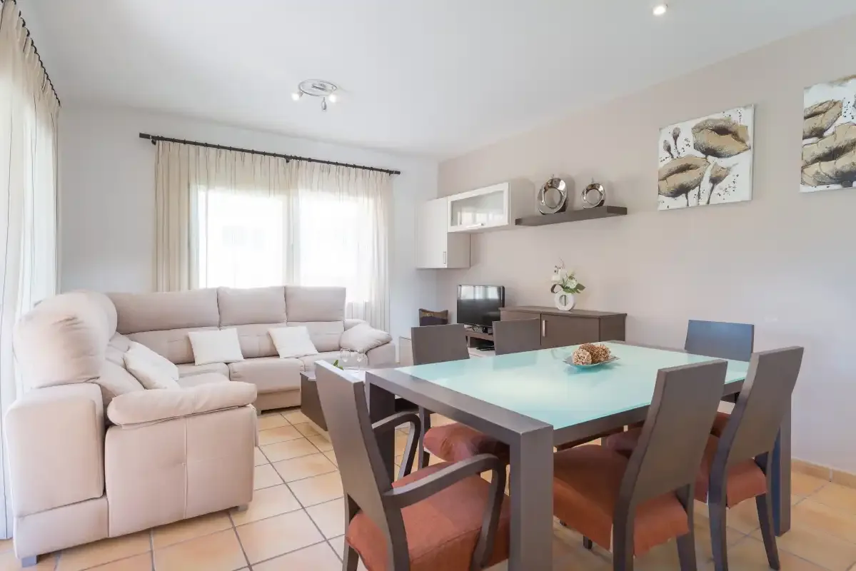 A living and dining room with seating around a table.
