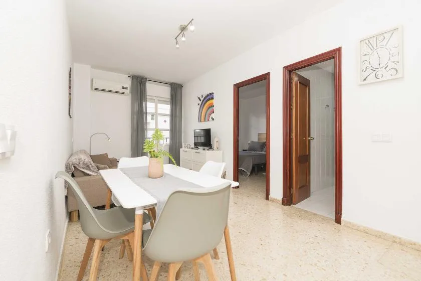 A bright dining area with a table and chairs beside an open doorway.