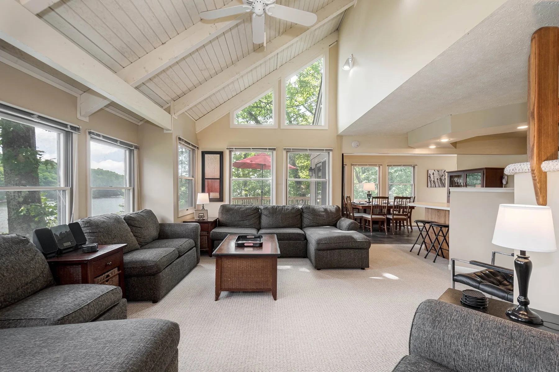 A spacious living room with seating, a coffee table, and a dining area.