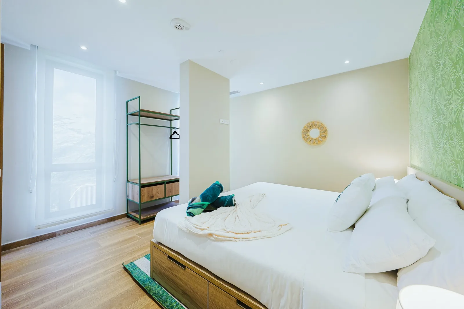Sink into crisp linens and let natural light fill your peaceful retreat, where minimalist design meets coastal comfort.