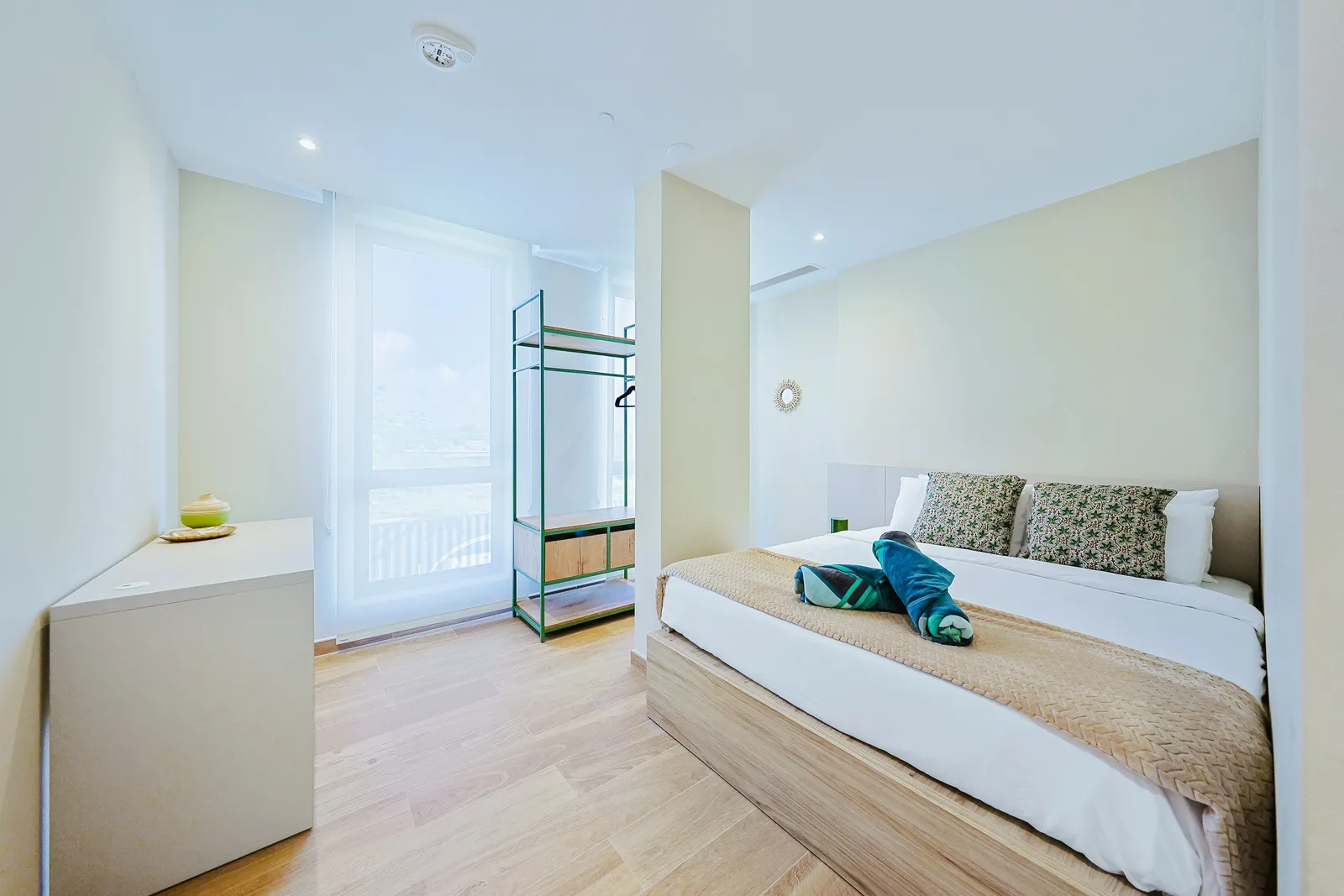 Slip into your serene sleeping space where calming tones and natural light create a peaceful sanctuary. Open shelving keeps your belongings organized, while soft linens invite restful nights.
