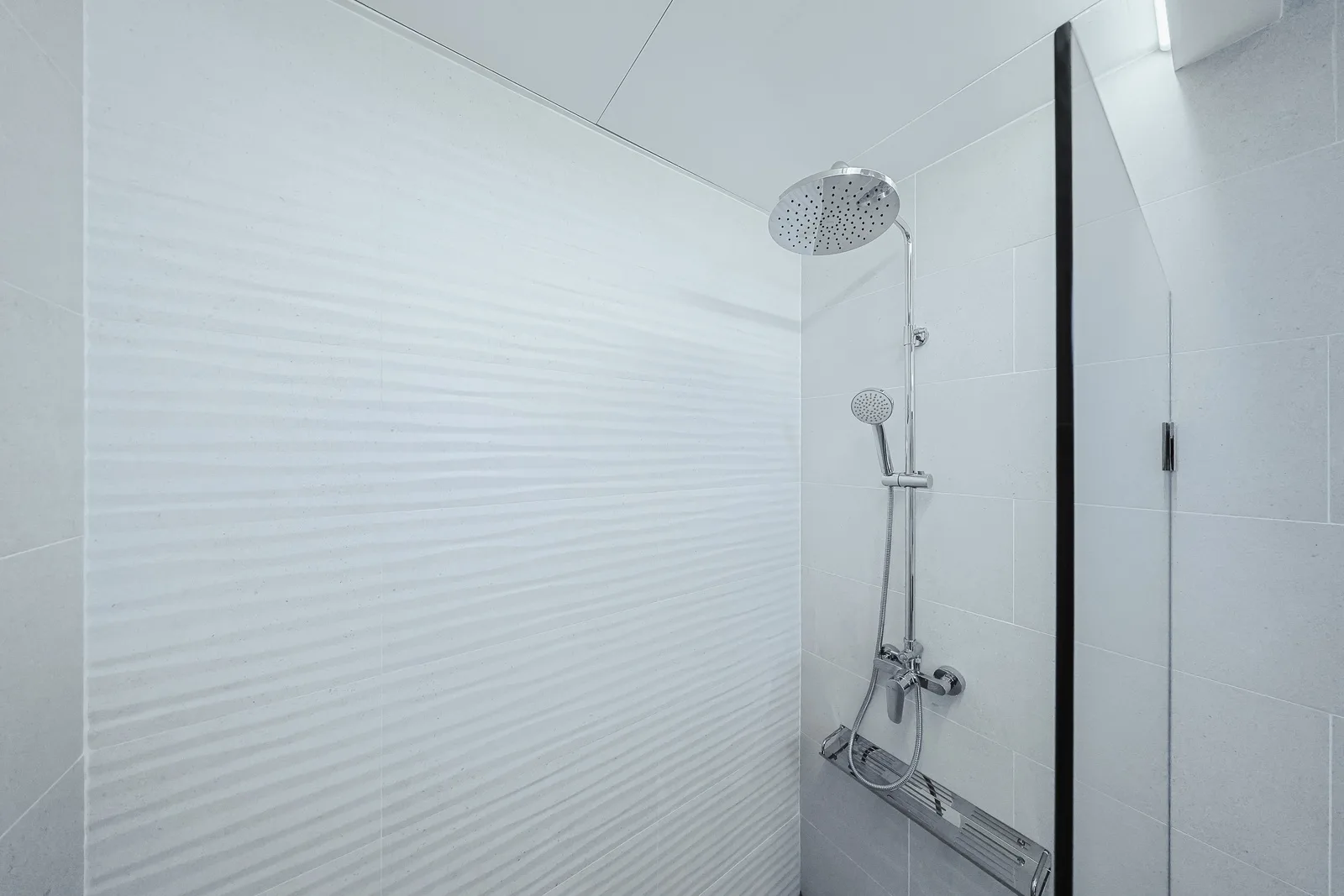 Step into your private rainfall shower, where sleek modern design meets pure relaxation with a glass-enclosed oasis.