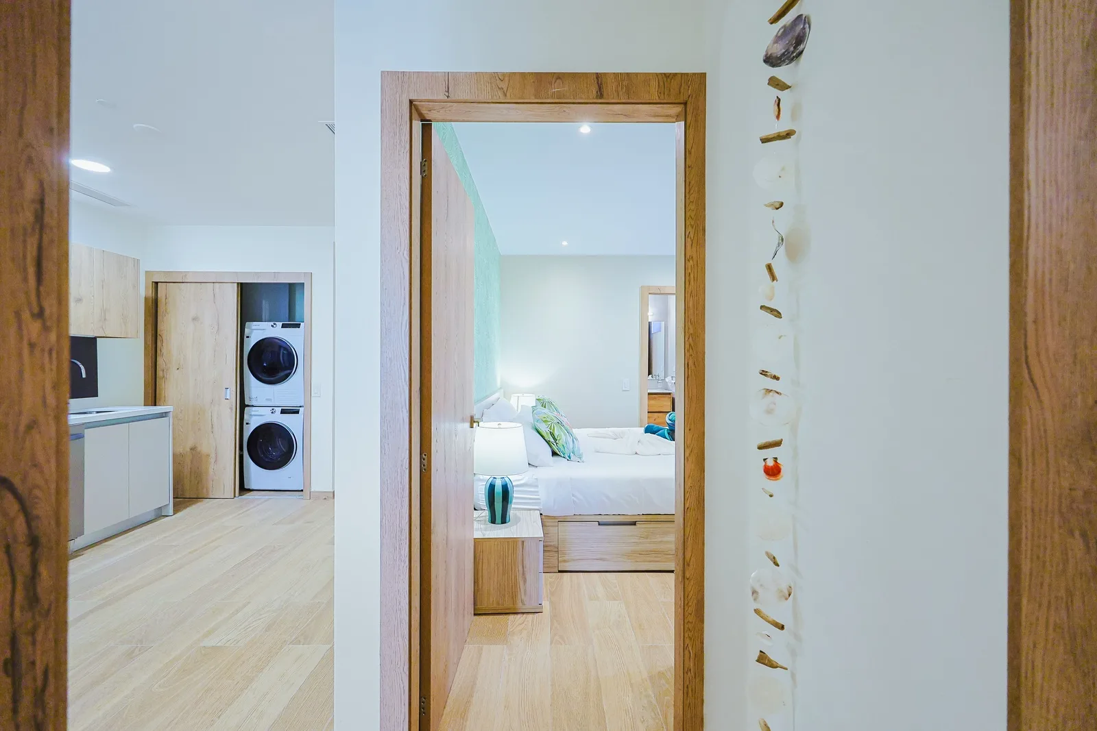 Step into your bright, modern retreat where coastal-inspired accents and warm wood tones create an inviting sanctuary for rest and relaxation.