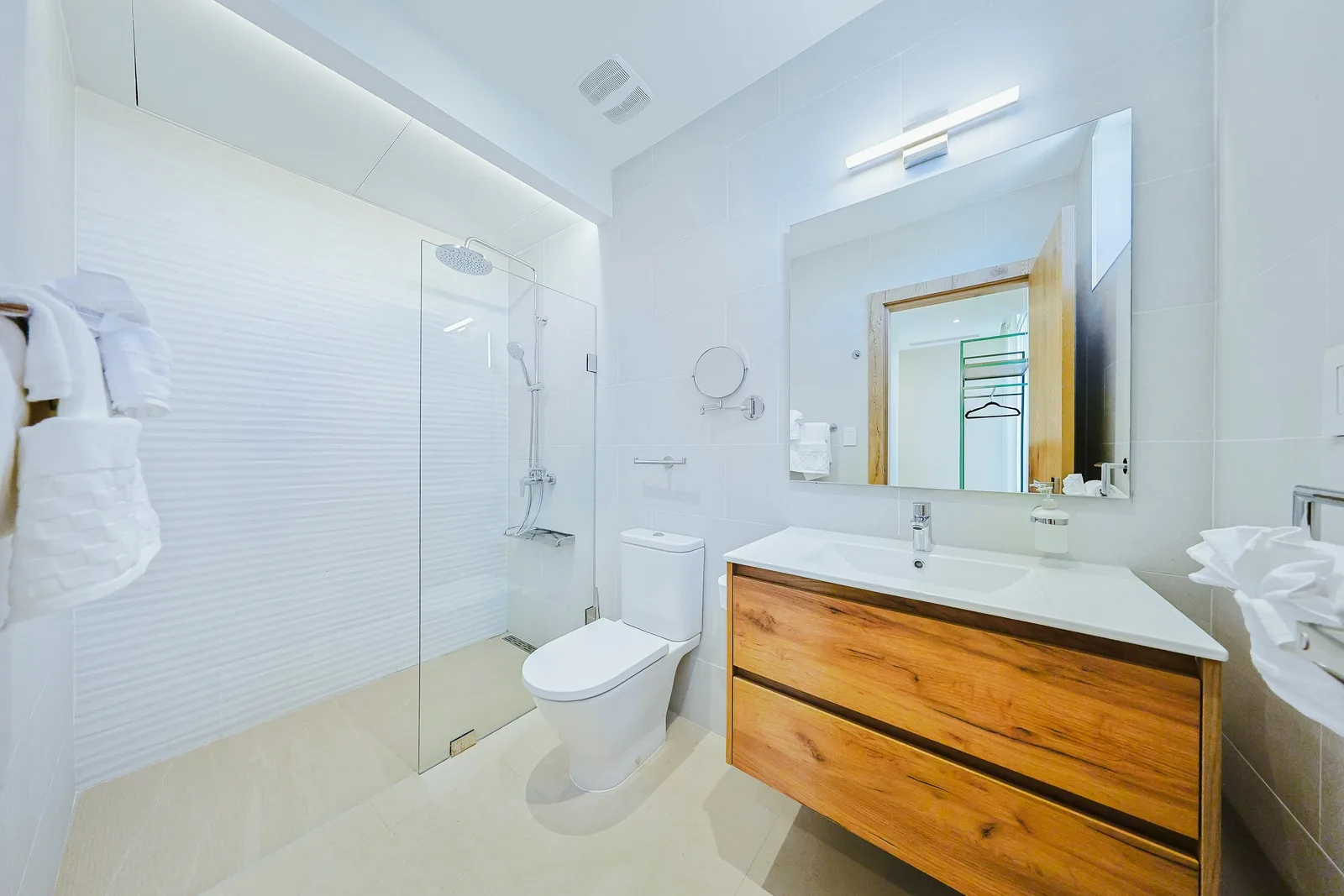 Step into your modern bathroom where clean lines meet warm wood accents. The spacious glass-enclosed shower and sleek vanity create a spa-like retreat for your daily refresh.