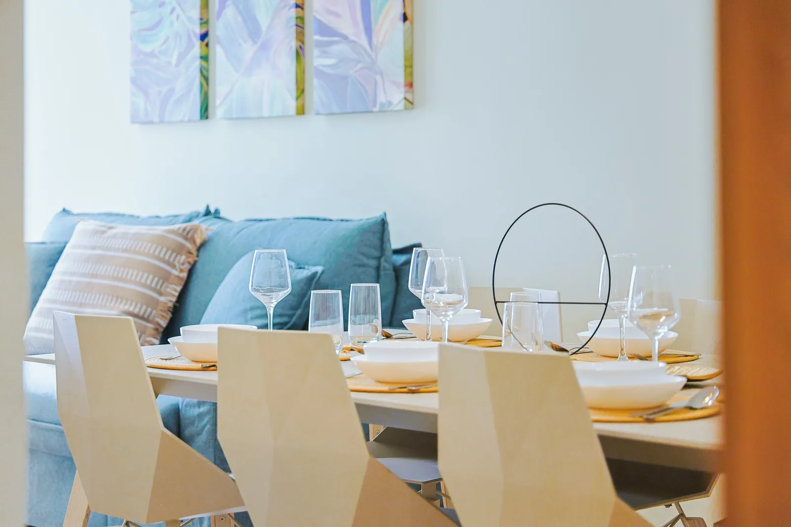 Gather around this elegant dining table beautifully set for your group, with a cozy lounge area just steps away for relaxing after meals.