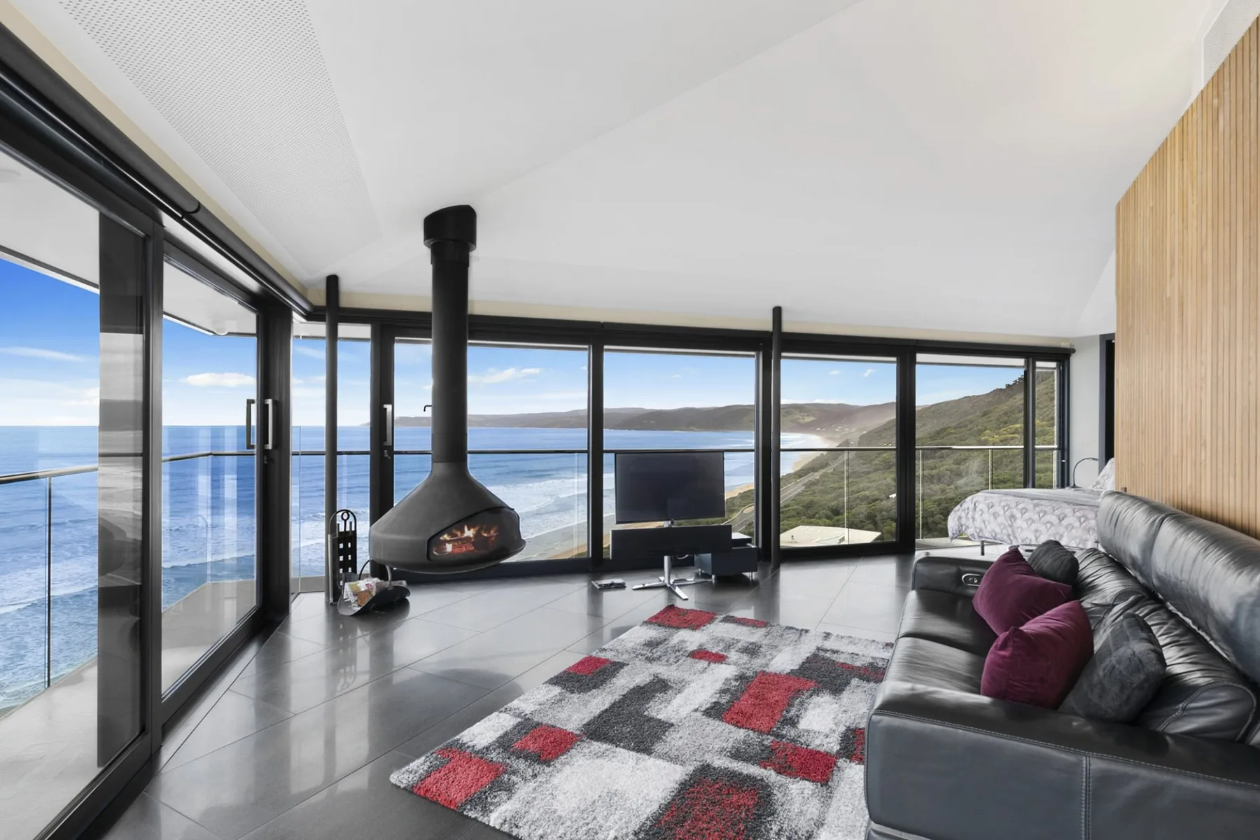 Living room with floor-to-ceiling windows overlooking the ocean.