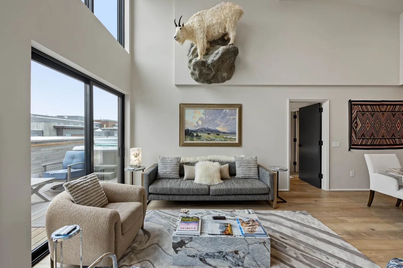 A bright living room with seating arranged around a low coffee table.