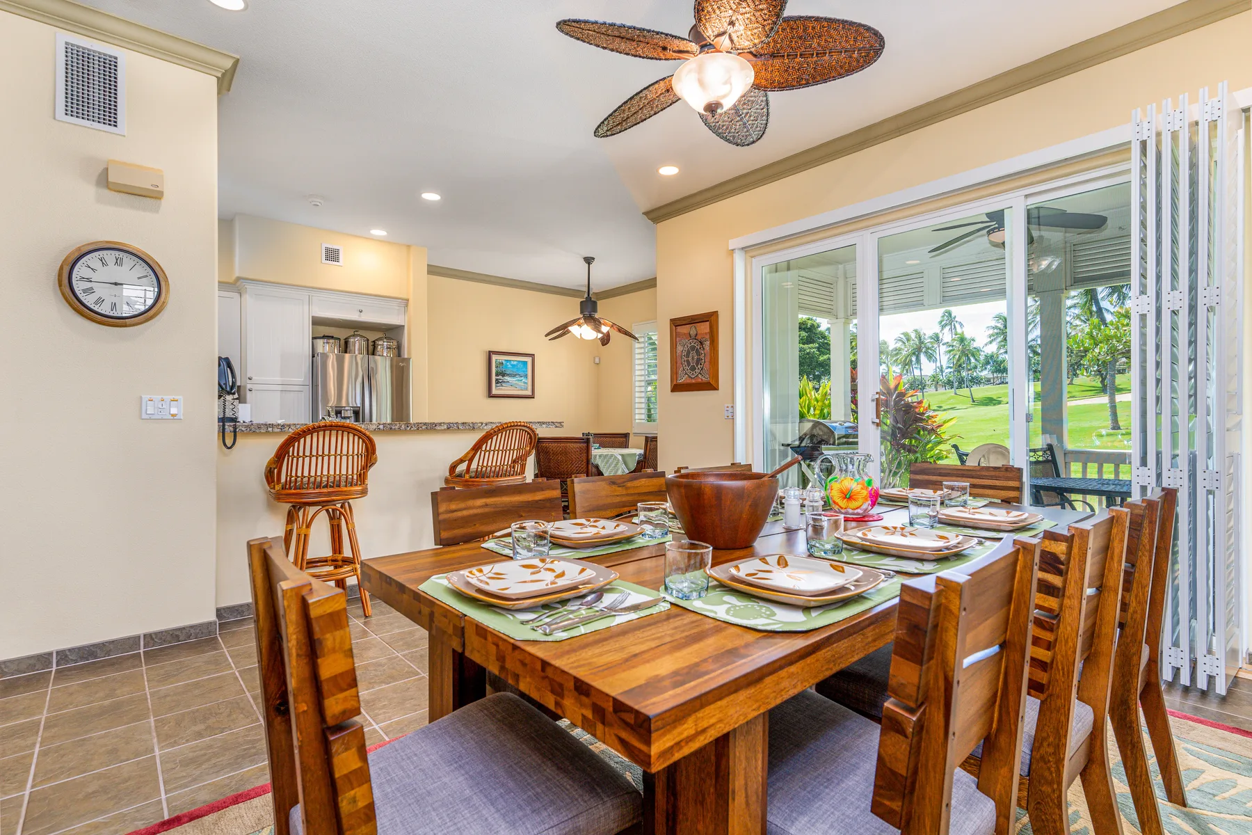 A dining area with a wooden table set beside large sliding glass doors.