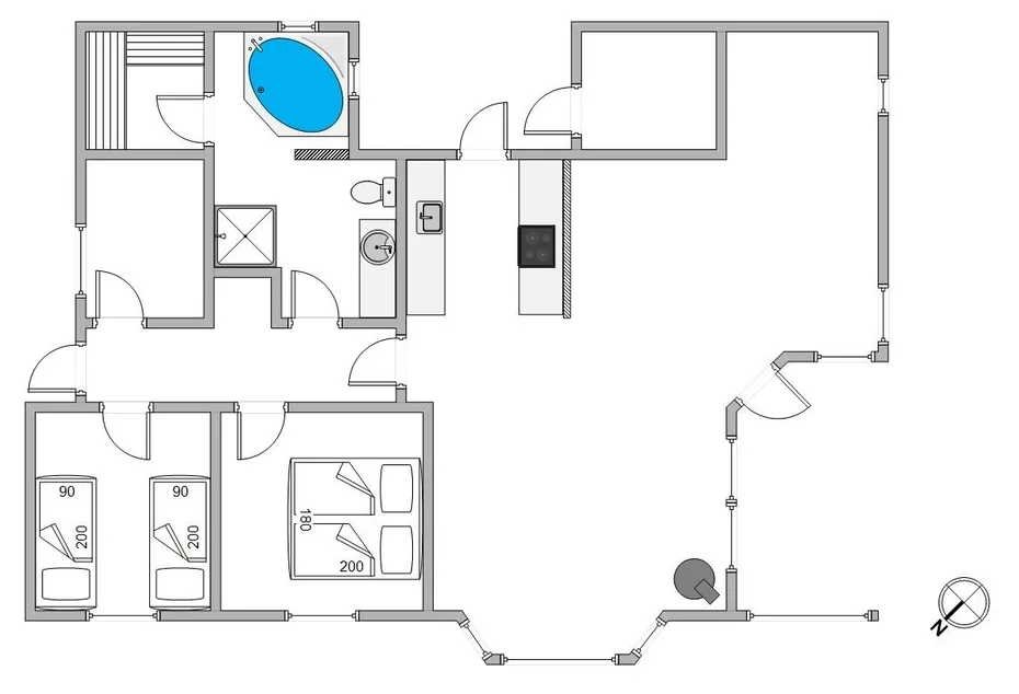 Un plano muestra varias habitaciones, elementos de baño y una amplia zona abierta.