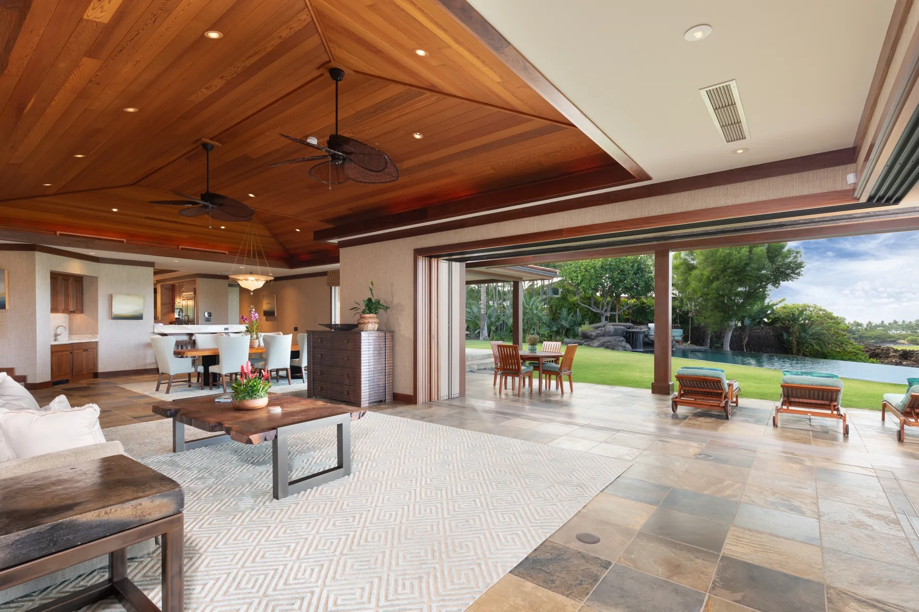 A spacious living and dining area opens onto a patio and garden.