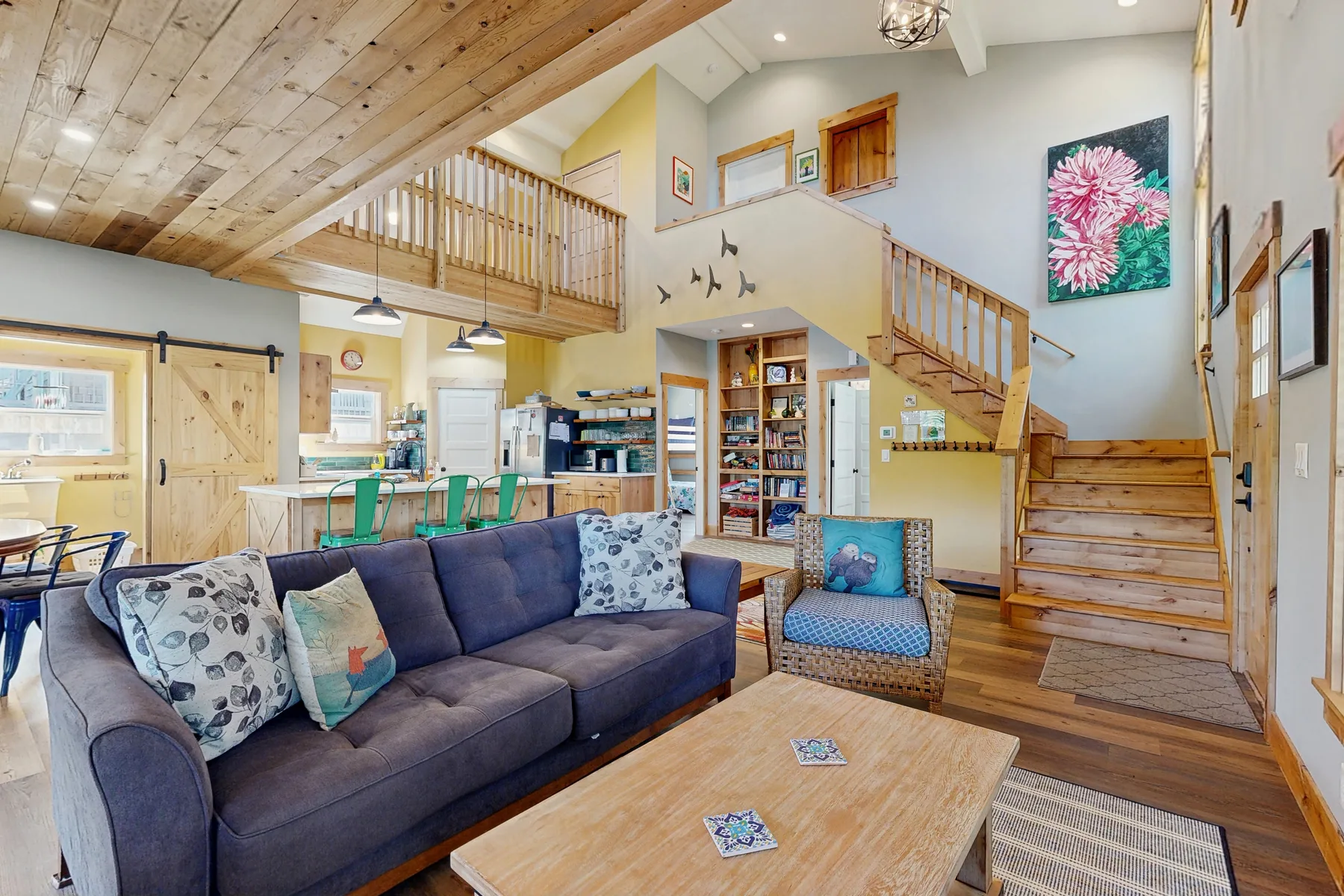 A living room with a sofa, coffee table, and wooden staircase.