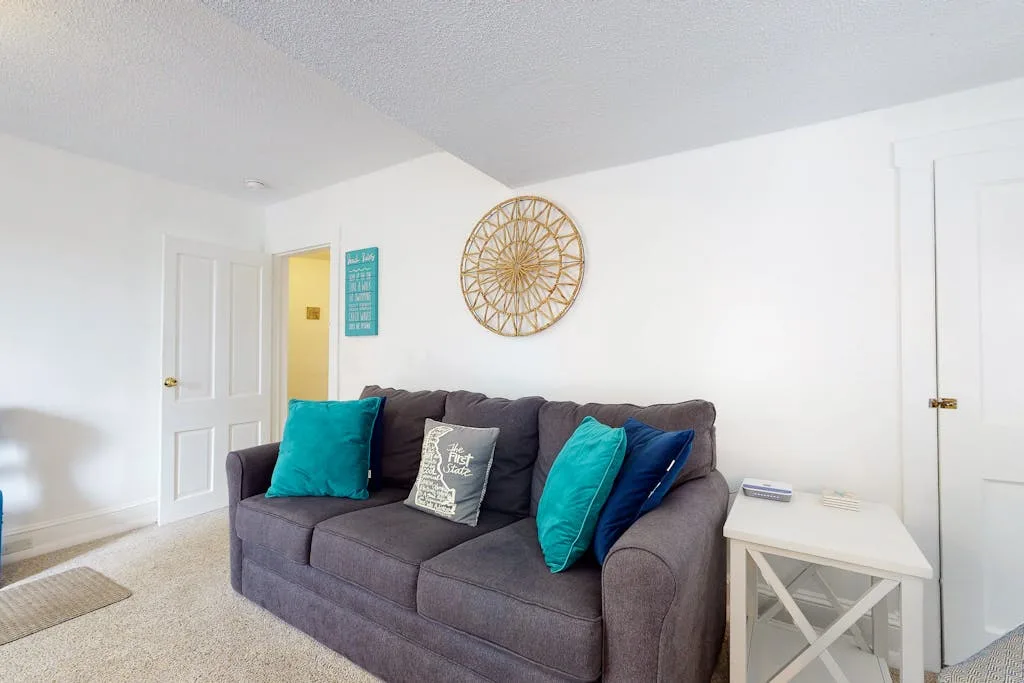 Living room with a gray sofa and colorful cushions.