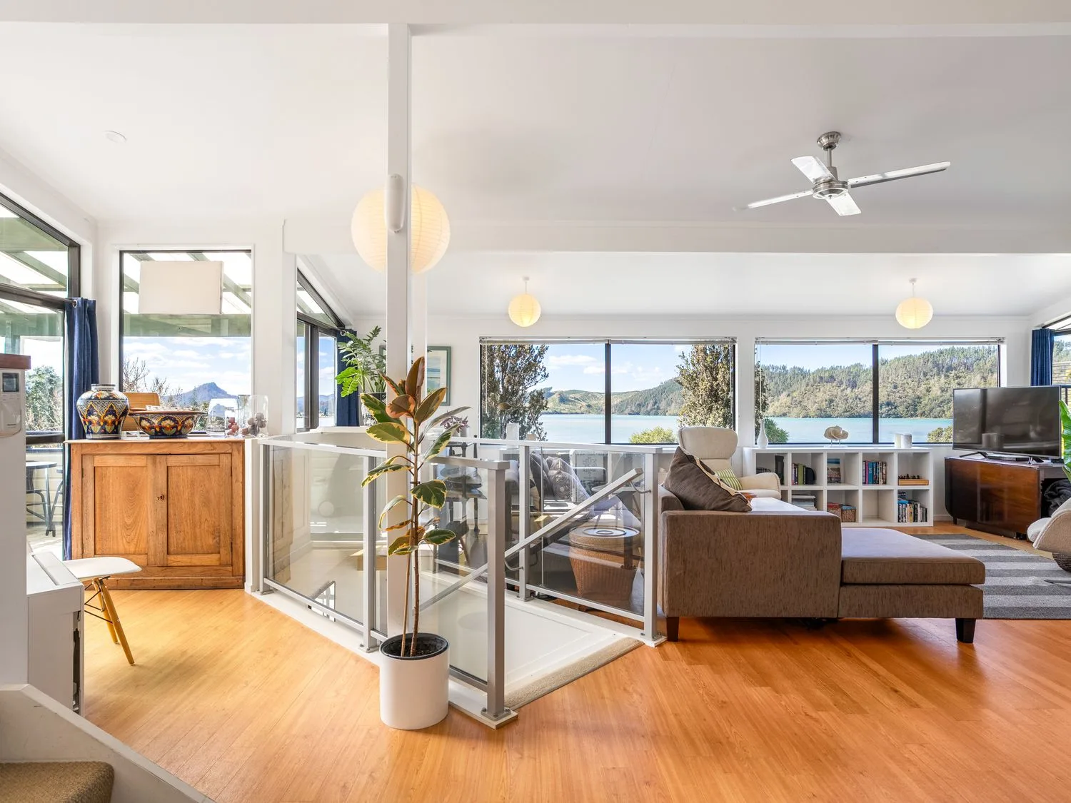 A living room with a sofa and television at Harbour house - Whangamata Holiday Home