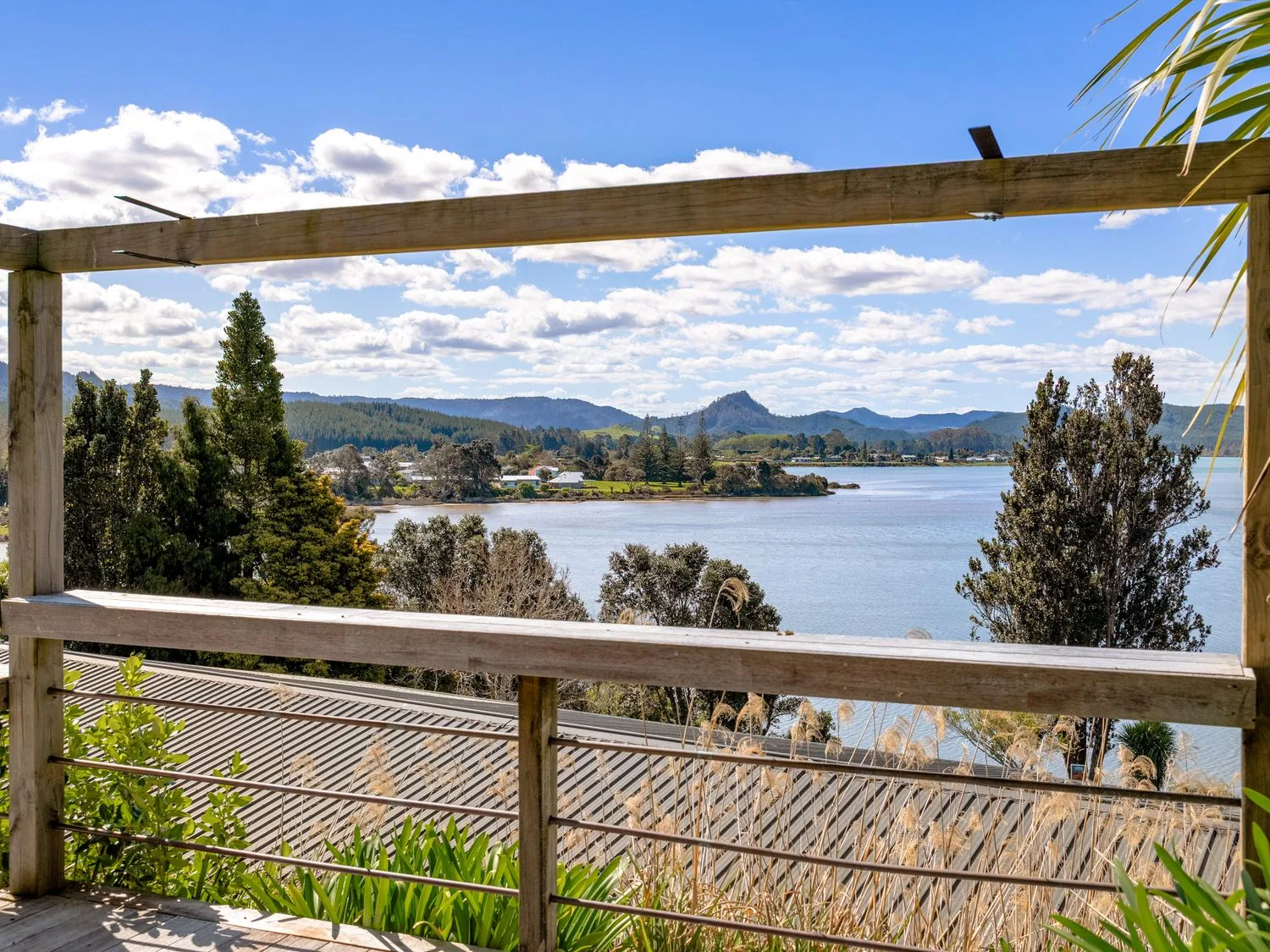 A view of water and mountains from a deck at Harbour house - Whangamata Holiday Home