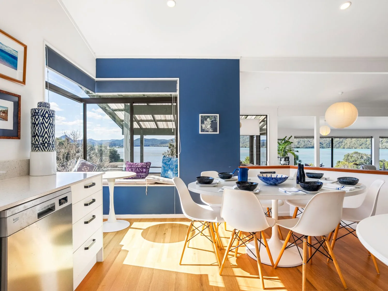 A dining room with a table and chairs at Harbour house - Whangamata Holiday Home
