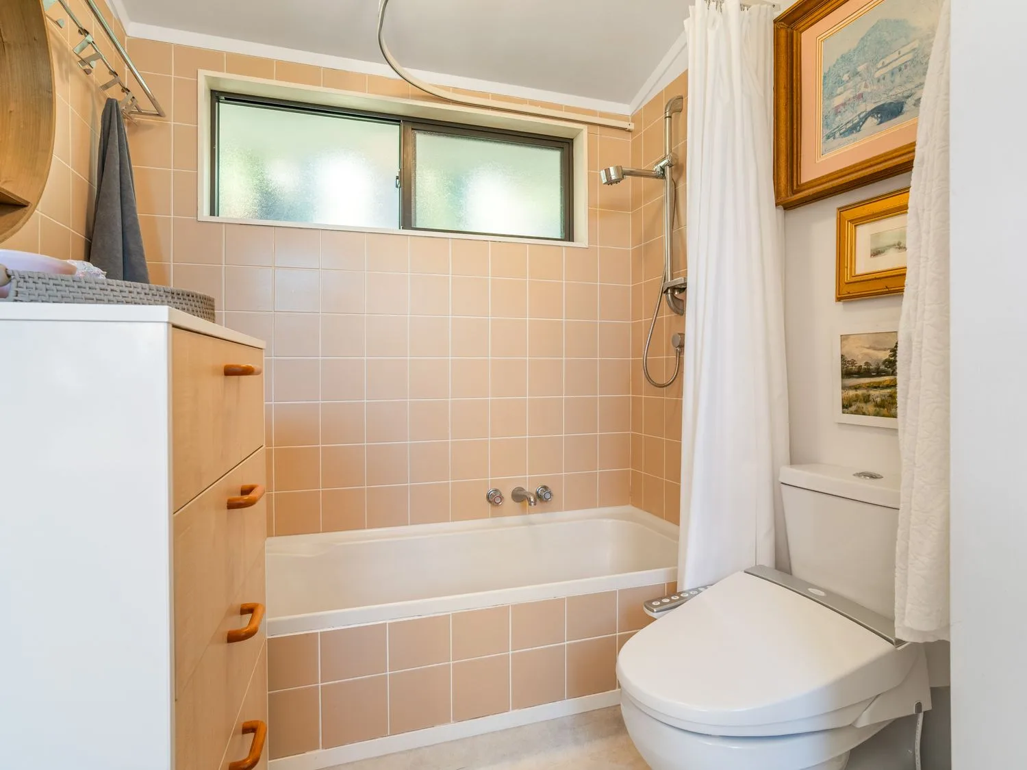A bathroom with a bathtub, toilet, and shower at Harbour house - Whangamata Holiday Home