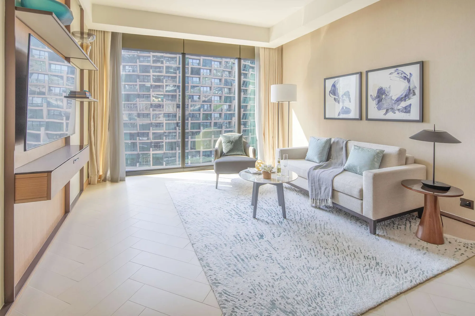 Living room with a seating area beside large windows and a patterned rug.