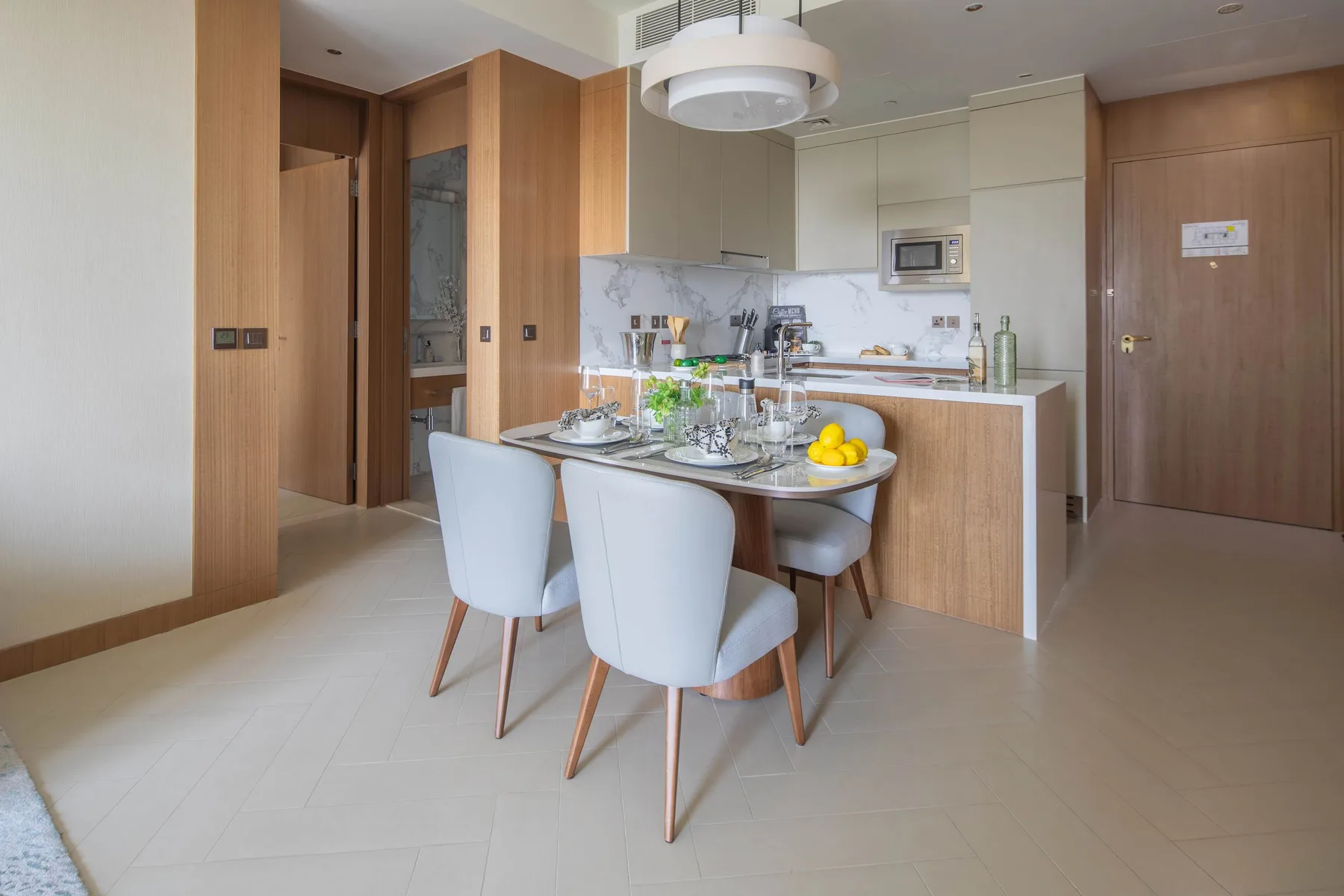A bright kitchen and dining area with a table set beside the kitchen counter.