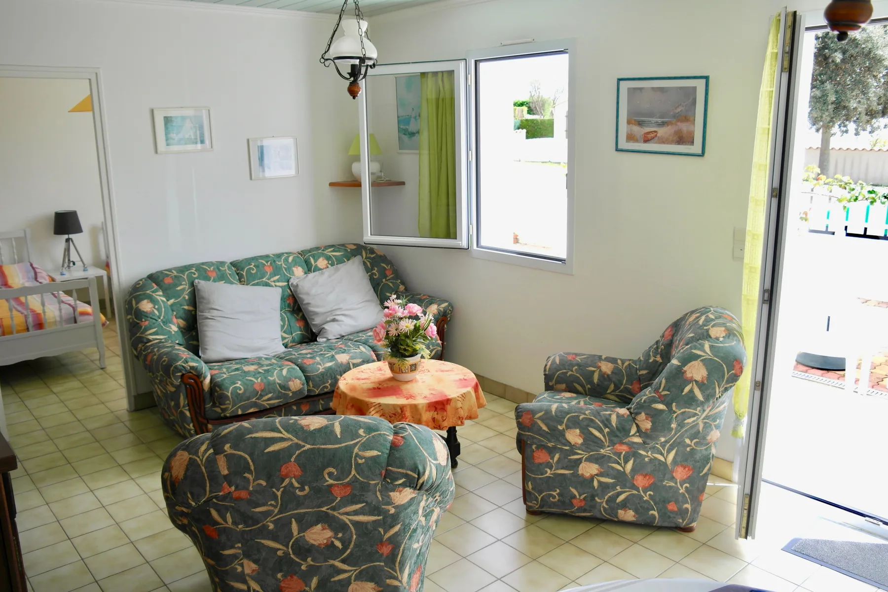 A living room with floral-patterned seating and a small table.