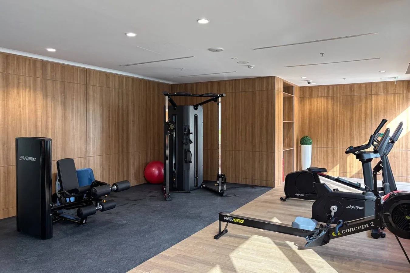 A gym with exercise machines and a weight-training station.