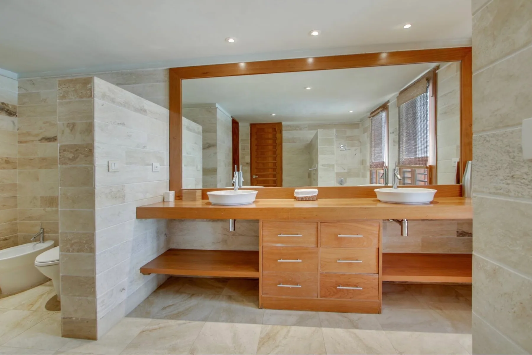 A spacious bathroom vanity with two sinks and a large mirror.