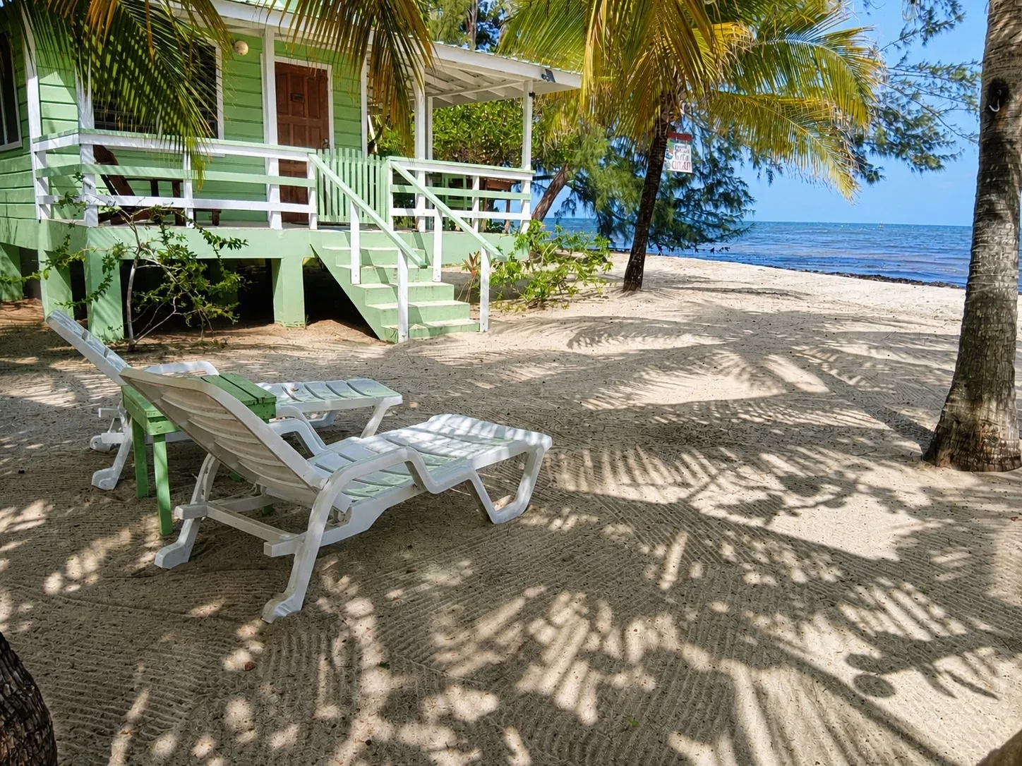 Beachfront cabana with shaded lounge chairs
