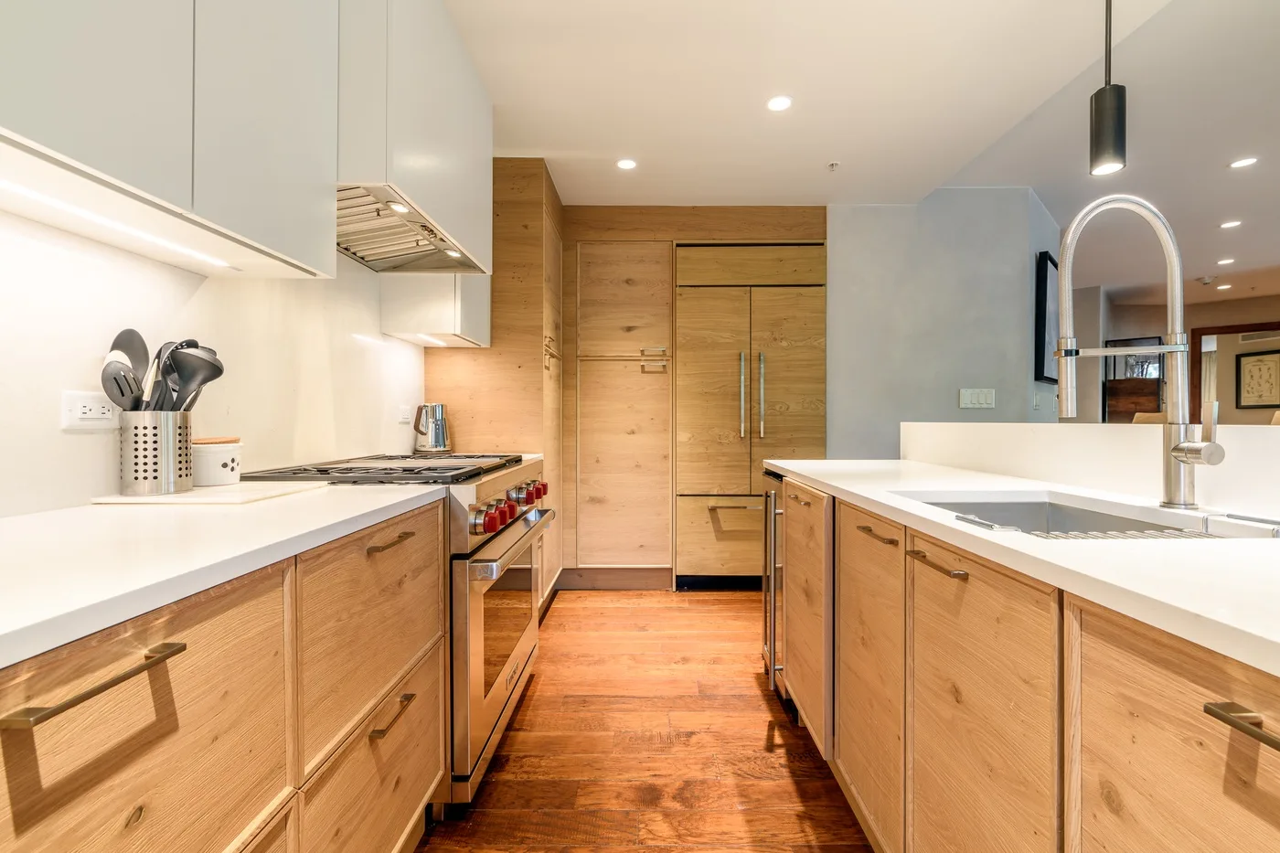 A bright kitchen with wood cabinetry, white counters, and a central island.