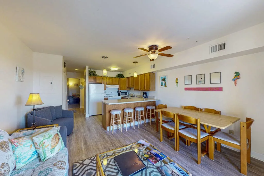 An open-plan living room and kitchen with a dining table and seating.