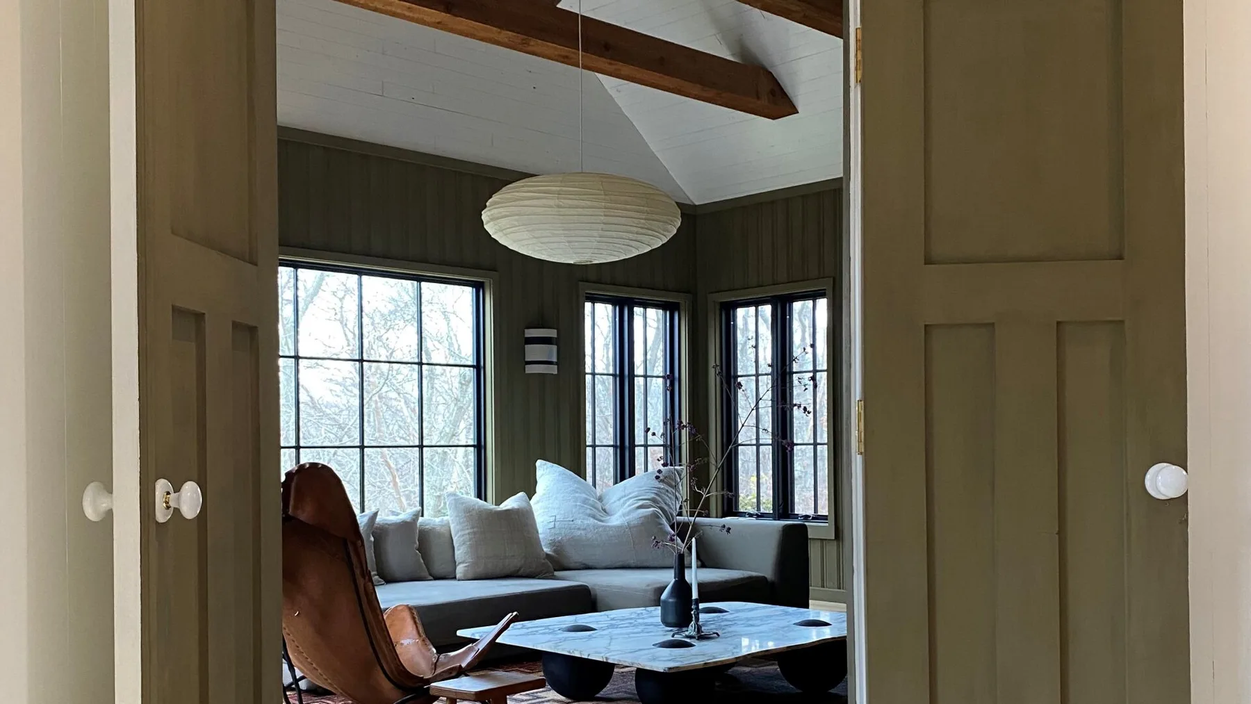 A living room with a sectional seating area and a low table.