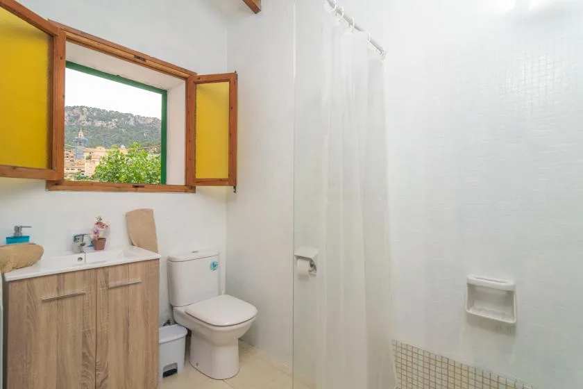 A bathroom with a sink, toilet, and shower.