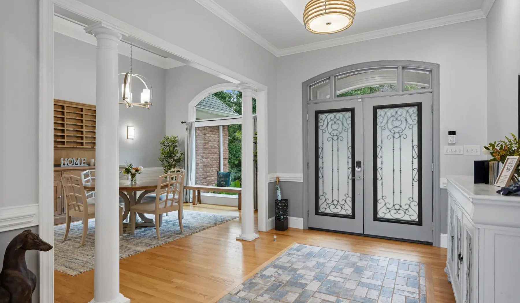 An entry hall with decorative glass double doors and a tiled floor.