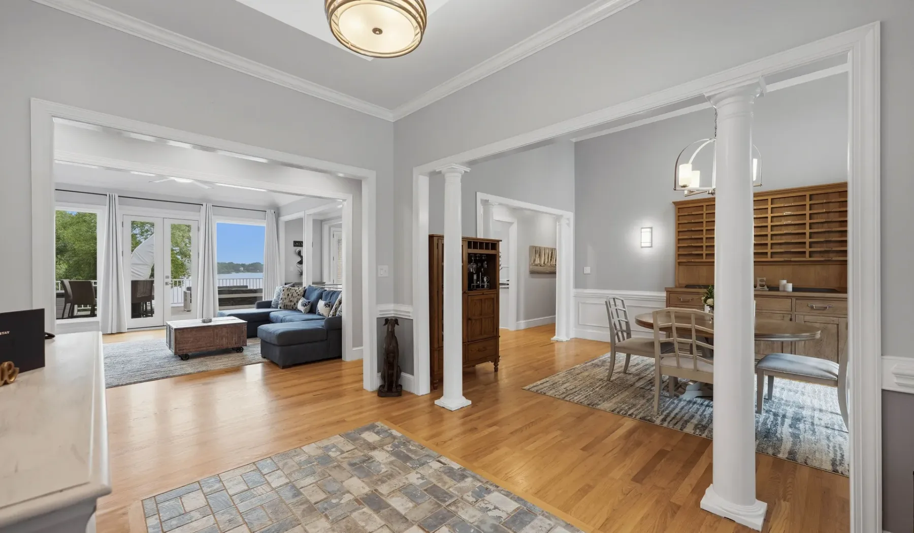 A bright open-plan living and dining area with wood floors and large windows.