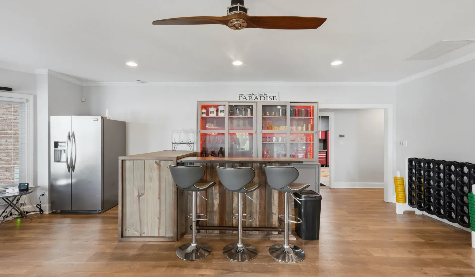 A bright kitchen and bar area with a central counter and stools.