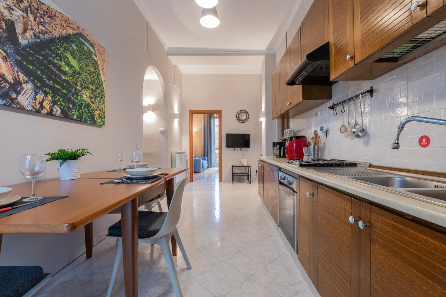 A kitchen and dining area with a long table beside the counter.