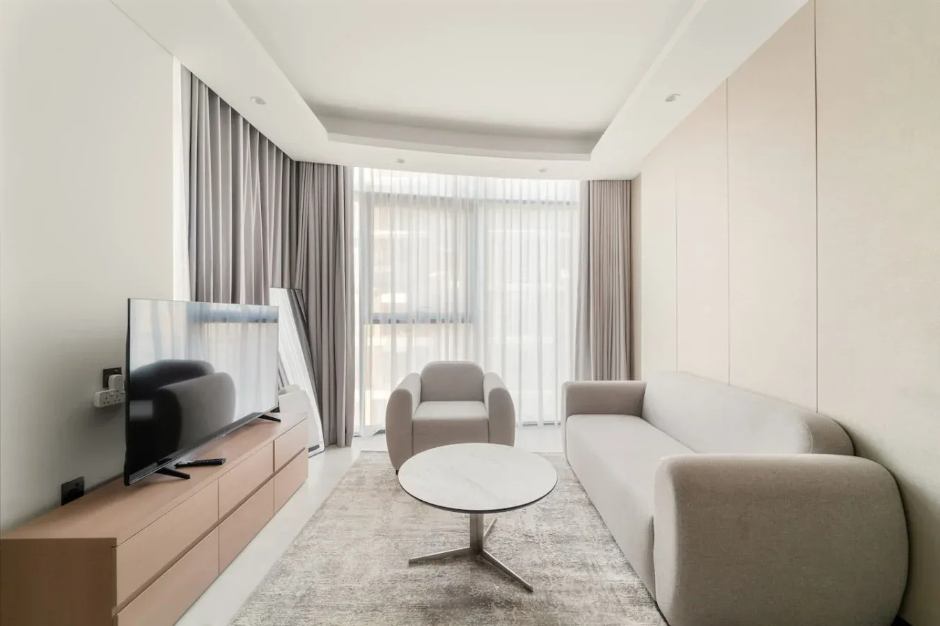 A bright living room with seating arranged around a low coffee table.