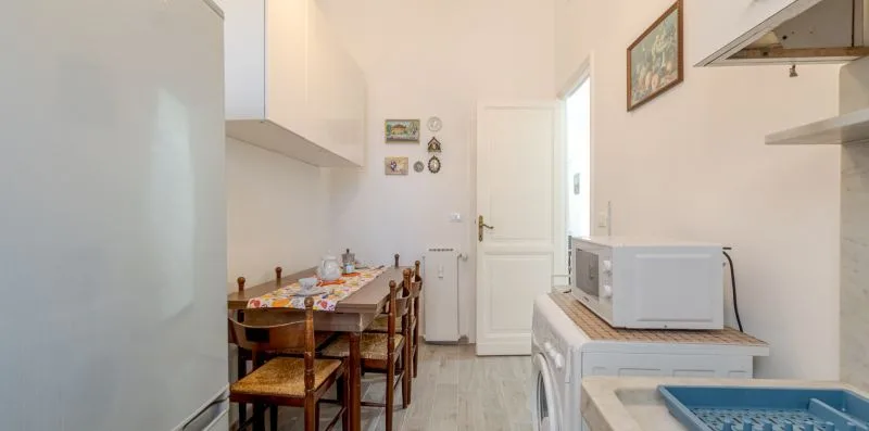 A compact kitchen and dining area with a table set beside the appliances.