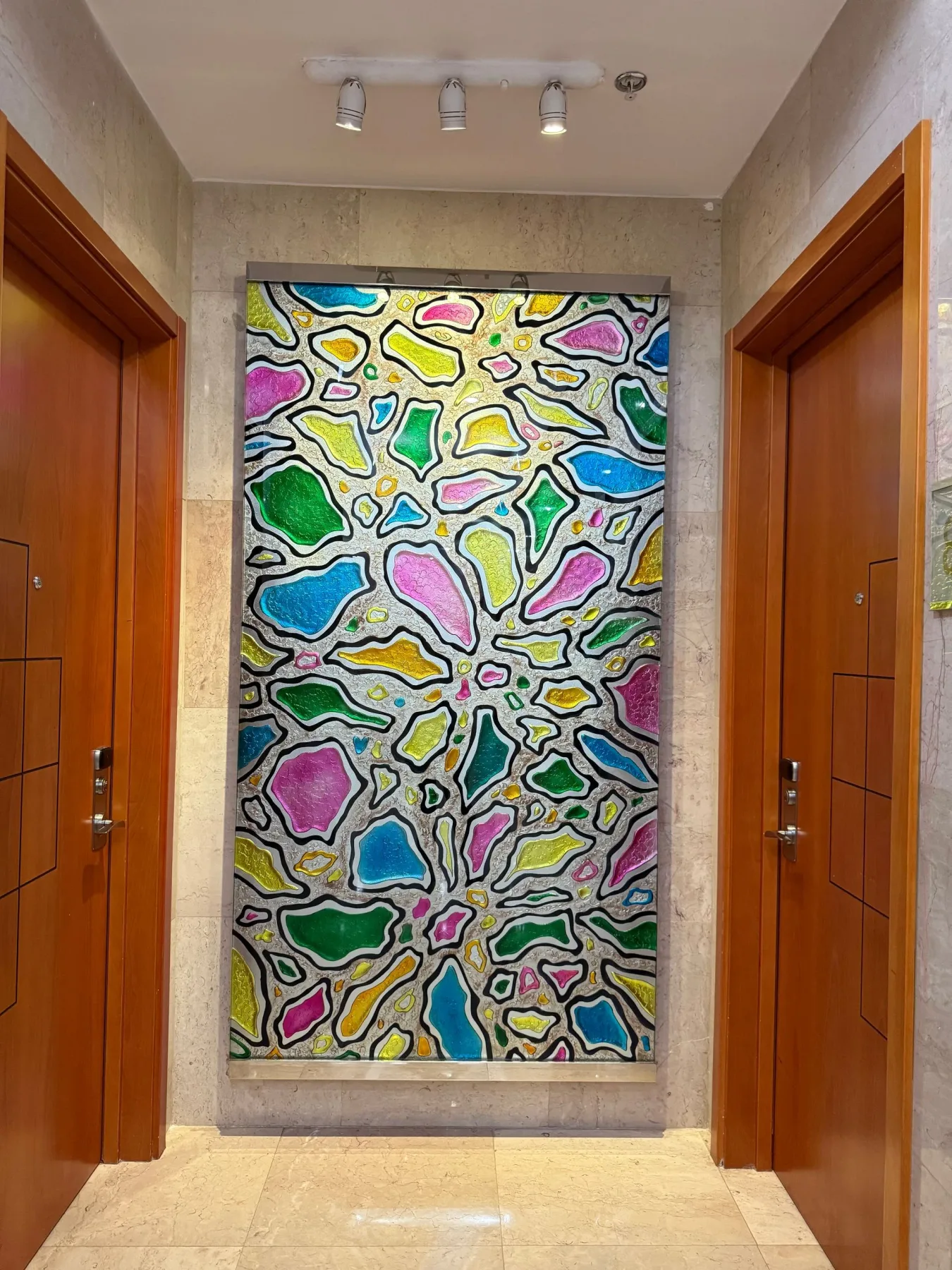 Abstract art panel in a hallway.