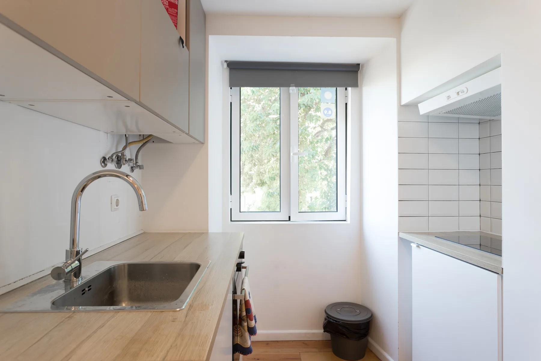 Una cocina compacta con fregadero, encimera y ventana.