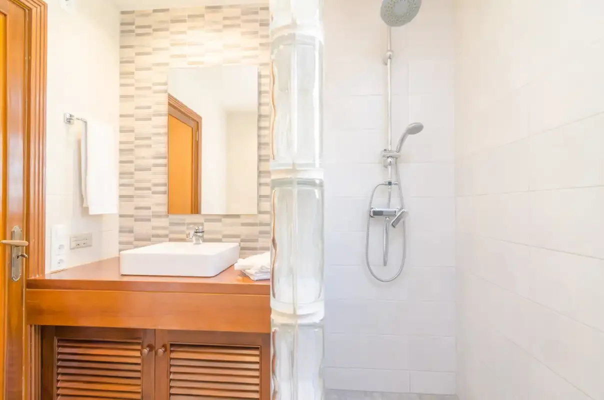 A bathroom with a sink and a shower.